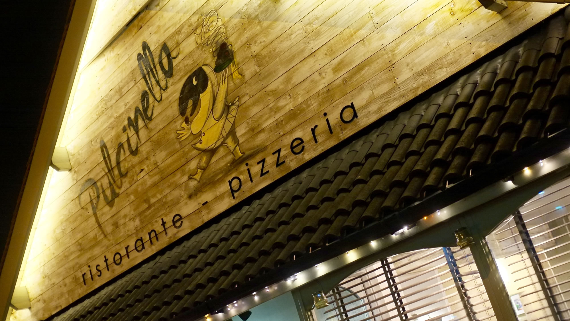 Close view of Pulcinella ristorante pizzeria timber sign