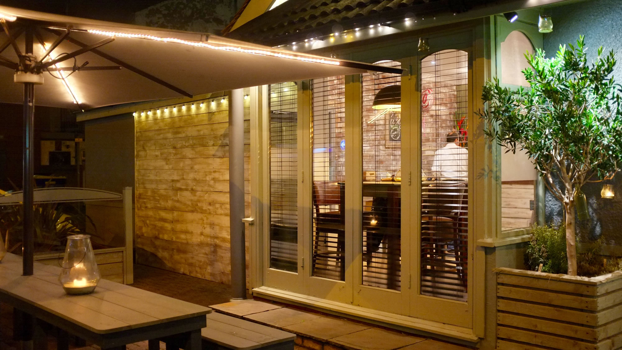 Pulcinella covered outdoor terrace and doors at night